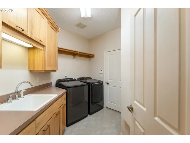 a bathroom with a granite countertop sink a mirror and a shower
