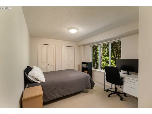 a bedroom with a bed and a large window