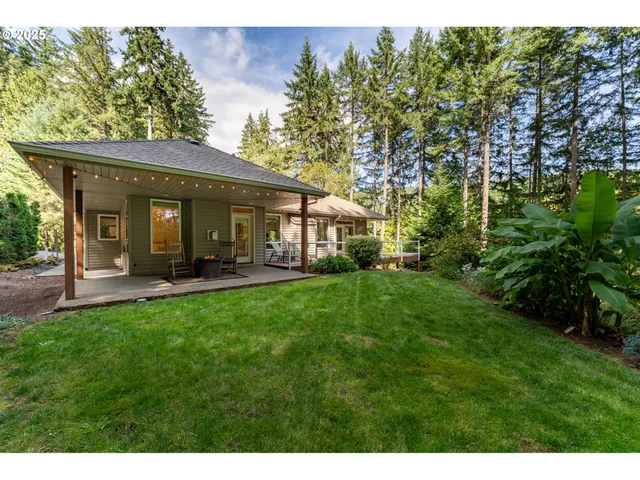 a view of a patio with a table chairs and a backyard