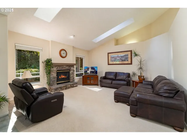 a living room with furniture a large window and a fireplace
