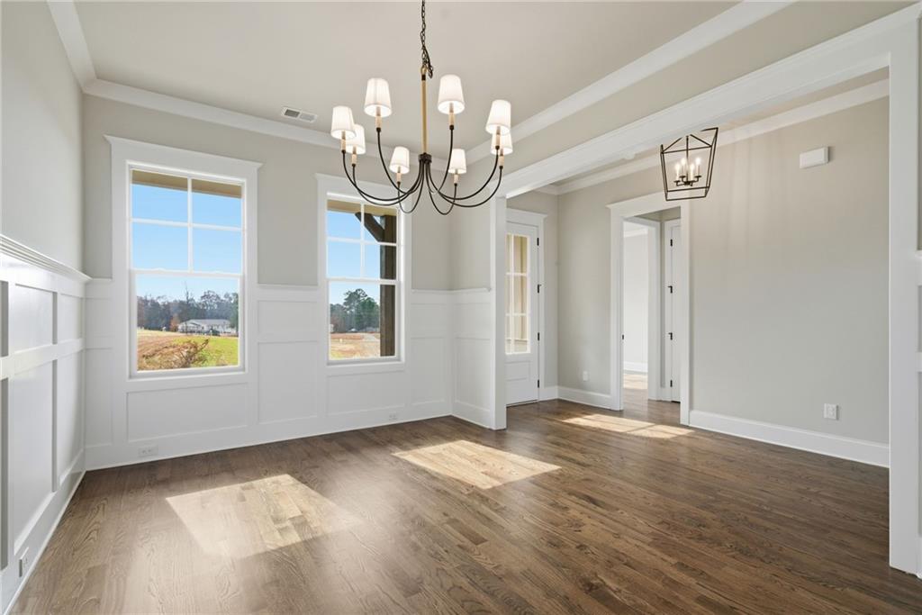5364 Price Road Gainesville, GA 30506 - Photo 11 of 59 a view of an empty room with wooden floor and windows