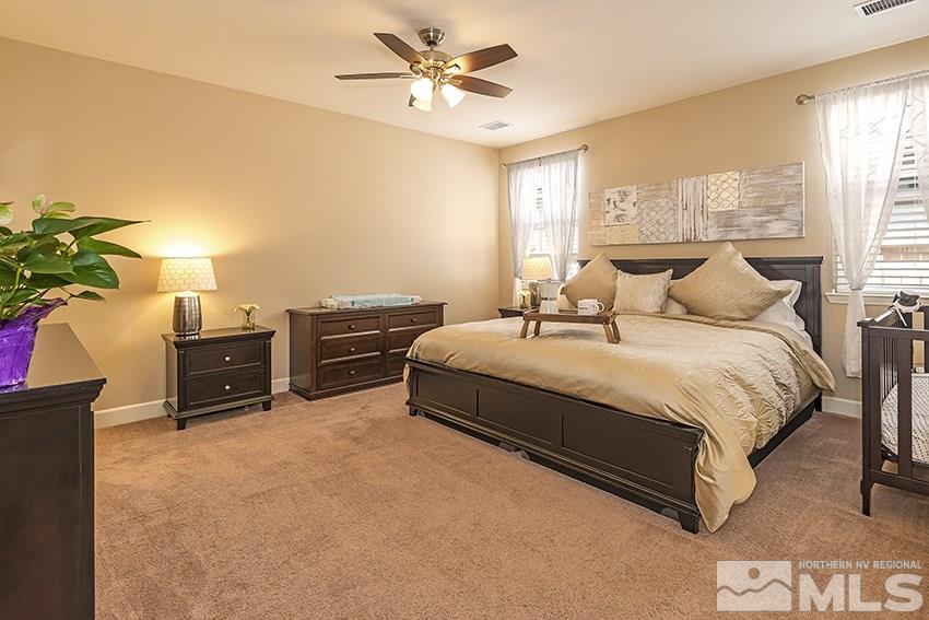 10171 Quintana Drive Reno, NV 89521 - Photo 13 of 25 a bedroom with a bed and a chandelier