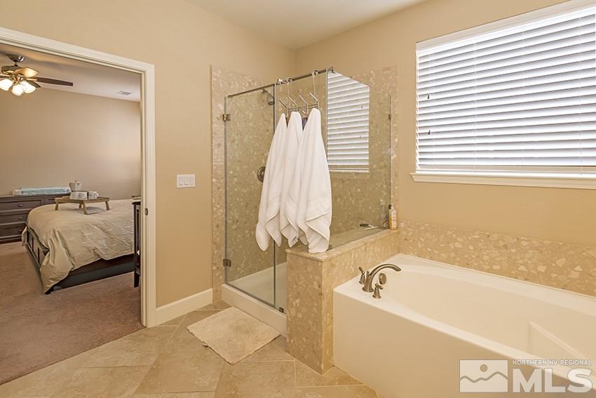 10171 Quintana Drive Reno, NV 89521 - Photo 16 of 25 a bathroom with a tub and a view of bathroom