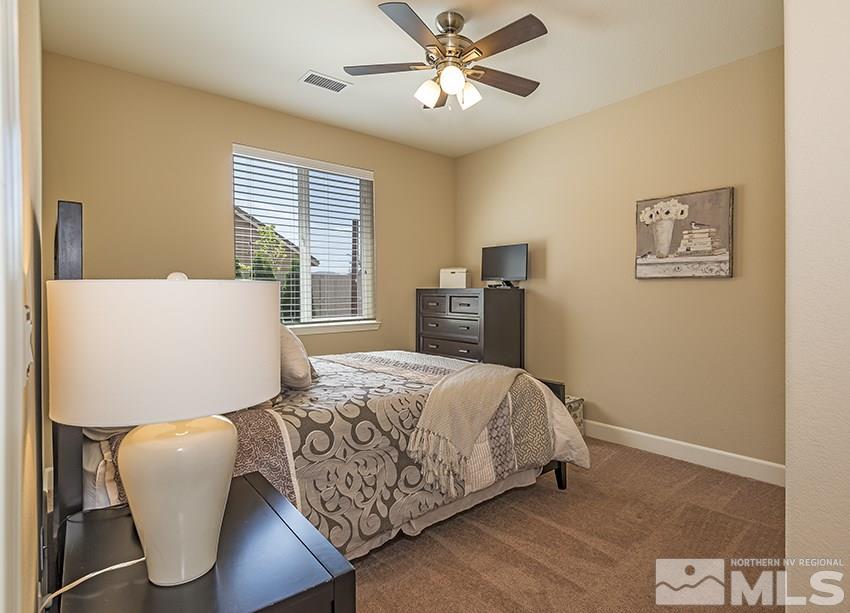 10171 Quintana Drive Reno, NV 89521 - Photo 17 of 25 a bedroom with a bed and wooden floor