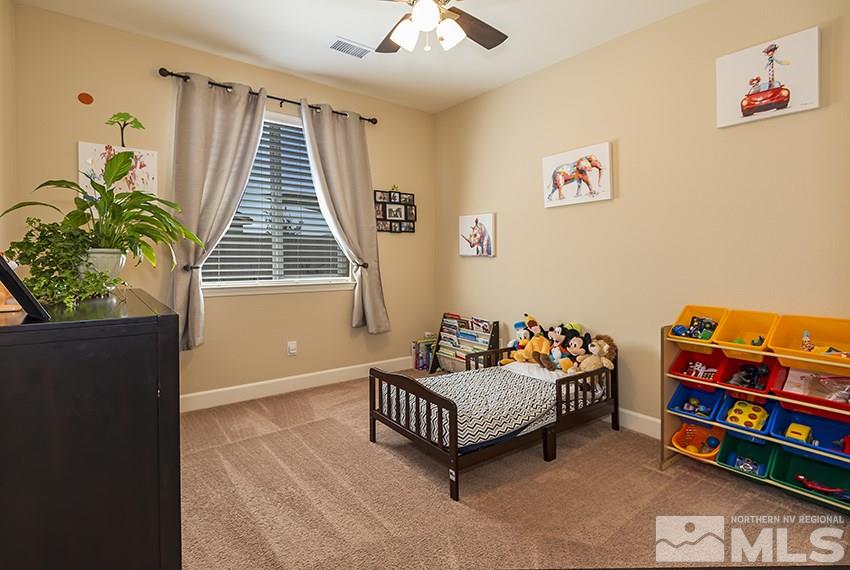 10171 Quintana Drive Reno, NV 89521 - Photo 20 of 25 a bedroom with furniture and a book shelf