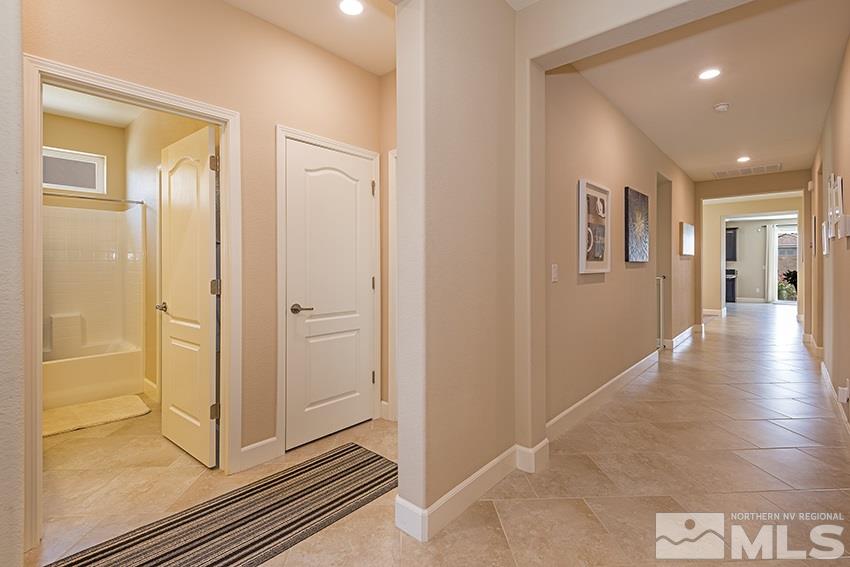 10171 Quintana Drive Reno, NV 89521 - Photo 5 of 25 a view of a hallway with wooden floor and a bathroom