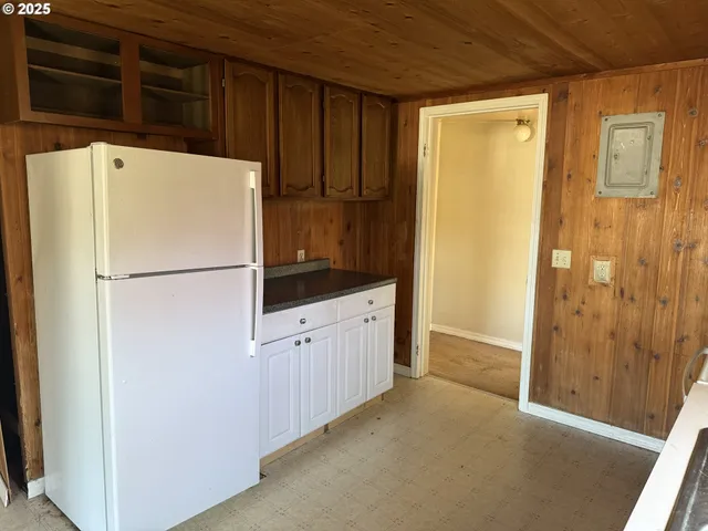 a white refrigerator freezer sitting inside of a kitchen