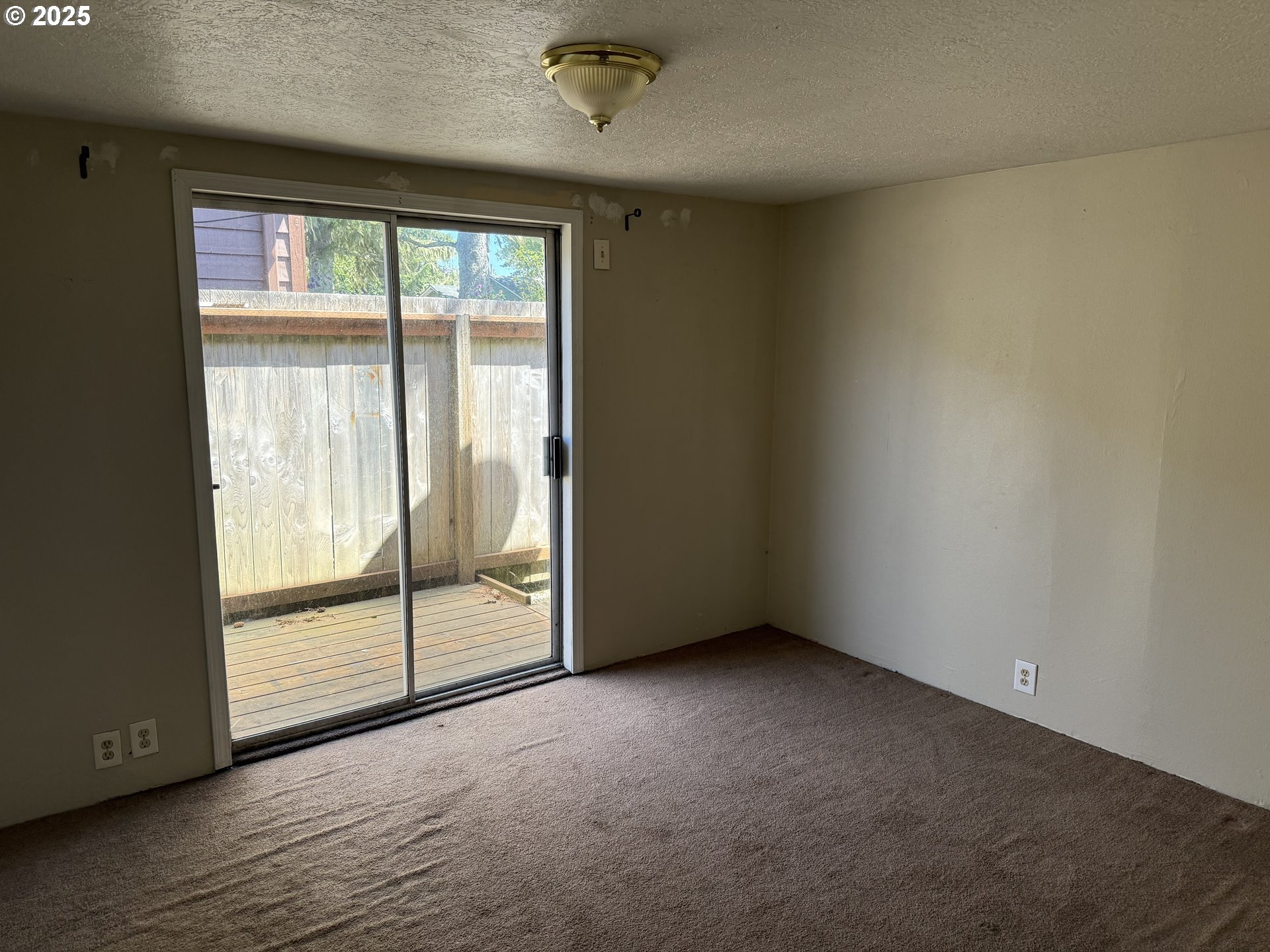 802 25th Avenue Seaside, OR 97138 - Photo 20 of 22 an empty room with wooden floor and door