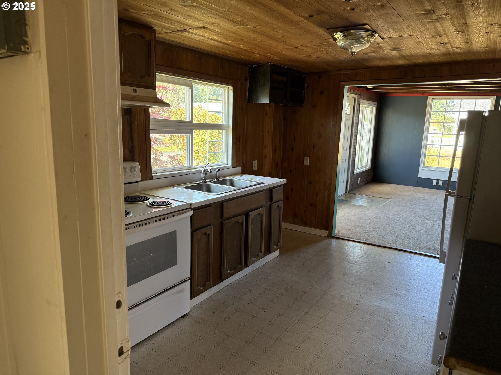 802 25th Avenue Seaside, OR 97138 - Photo 10 of 22 a kitchen with stainless steel appliances granite countertop a stove a sink and a refrigerator