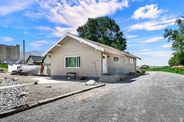 716 East Factory Street Garland, UT 84312 - Photo 2 of 30 Ranch-style residence featuring horizontal siding and a gravel driveway