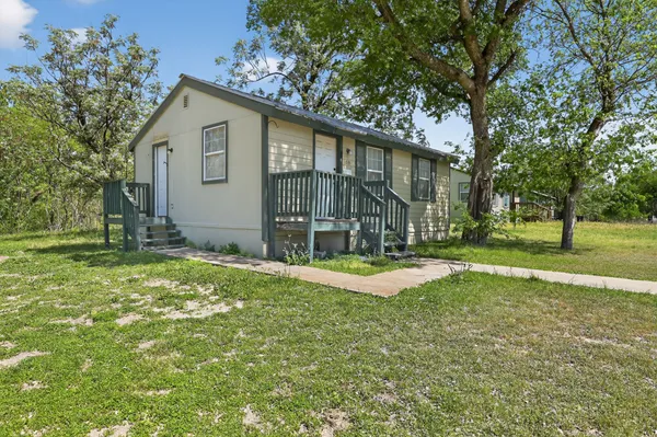 a view of a house with yard and tree s