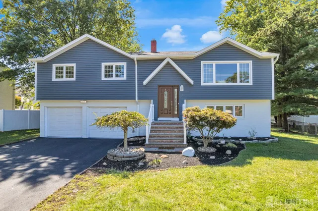 a front view of a house with swimming pool and porch