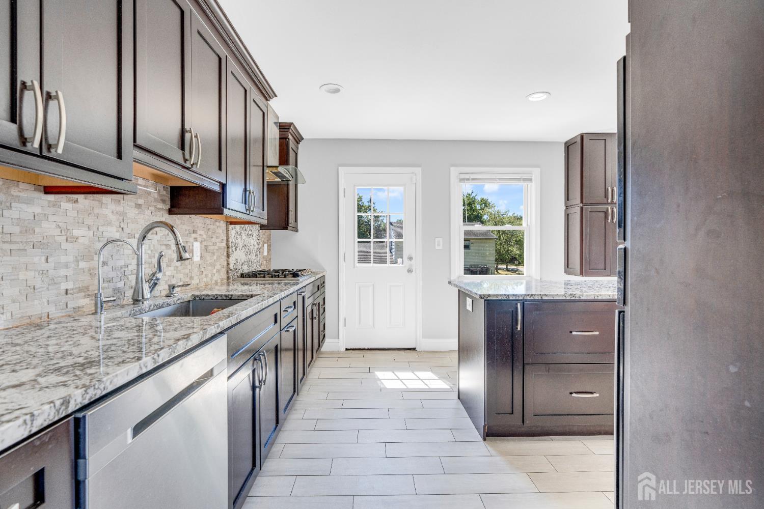 6 Marc Court Edison, NJ 08820 - Photo 13 of 42 a kitchen with stainless steel appliances granite countertop a sink and dishwasher a stove with wooden cabinets
