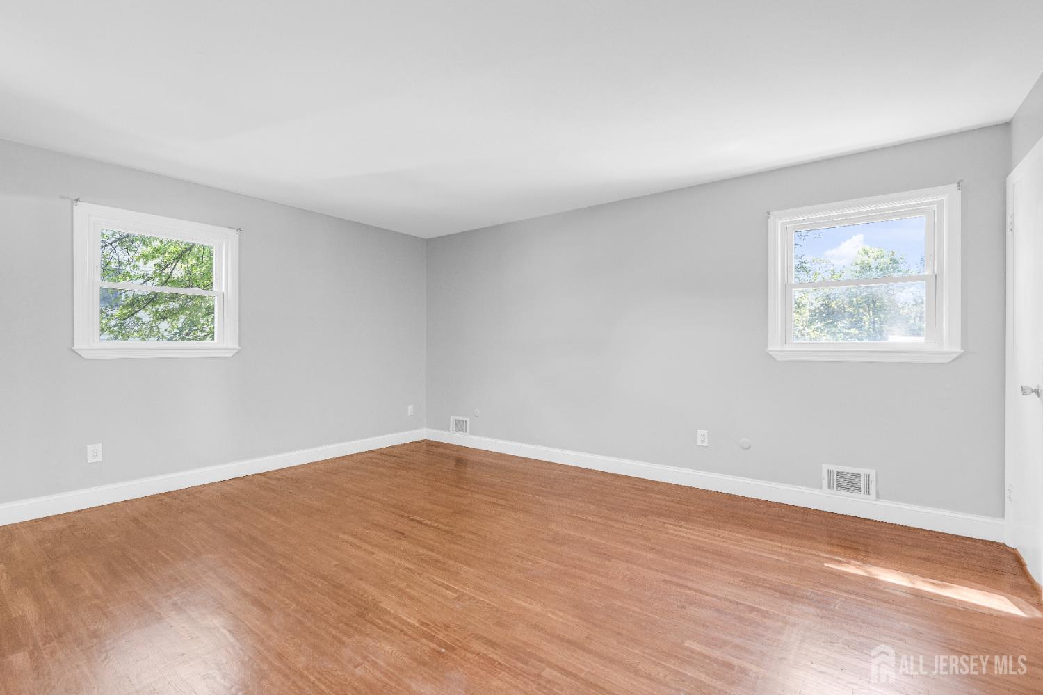 6 Marc Court Edison, NJ 08820 - Photo 17 of 42 a view of an empty room with wooden floor and a window