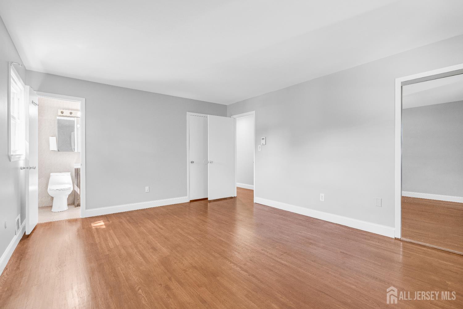 6 Marc Court Edison, NJ 08820 - Photo 18 of 42 a view of an empty room with wooden floor and a window