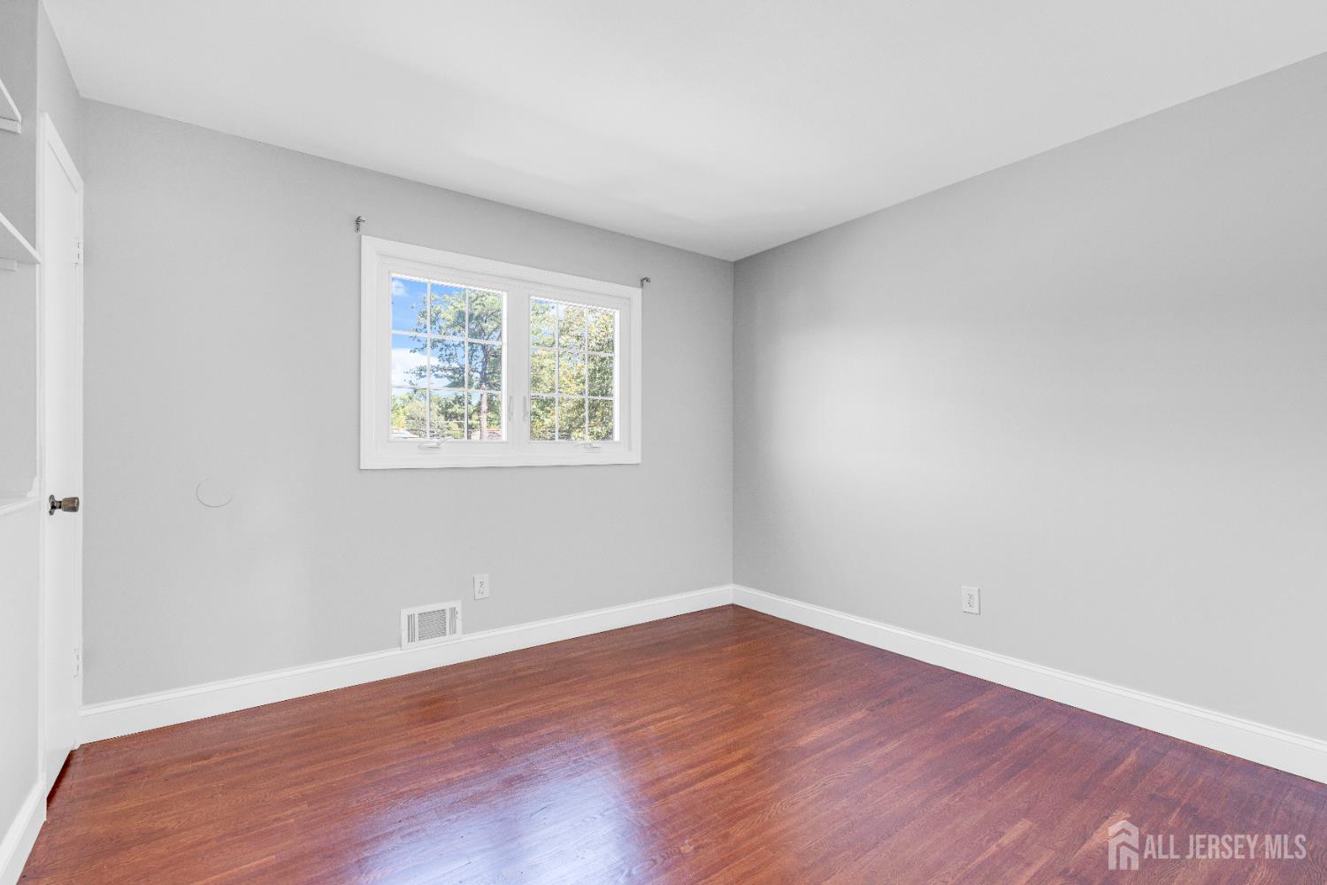 6 Marc Court Edison, NJ 08820 - Photo 21 of 42 a view of an empty room with wooden floor and a window