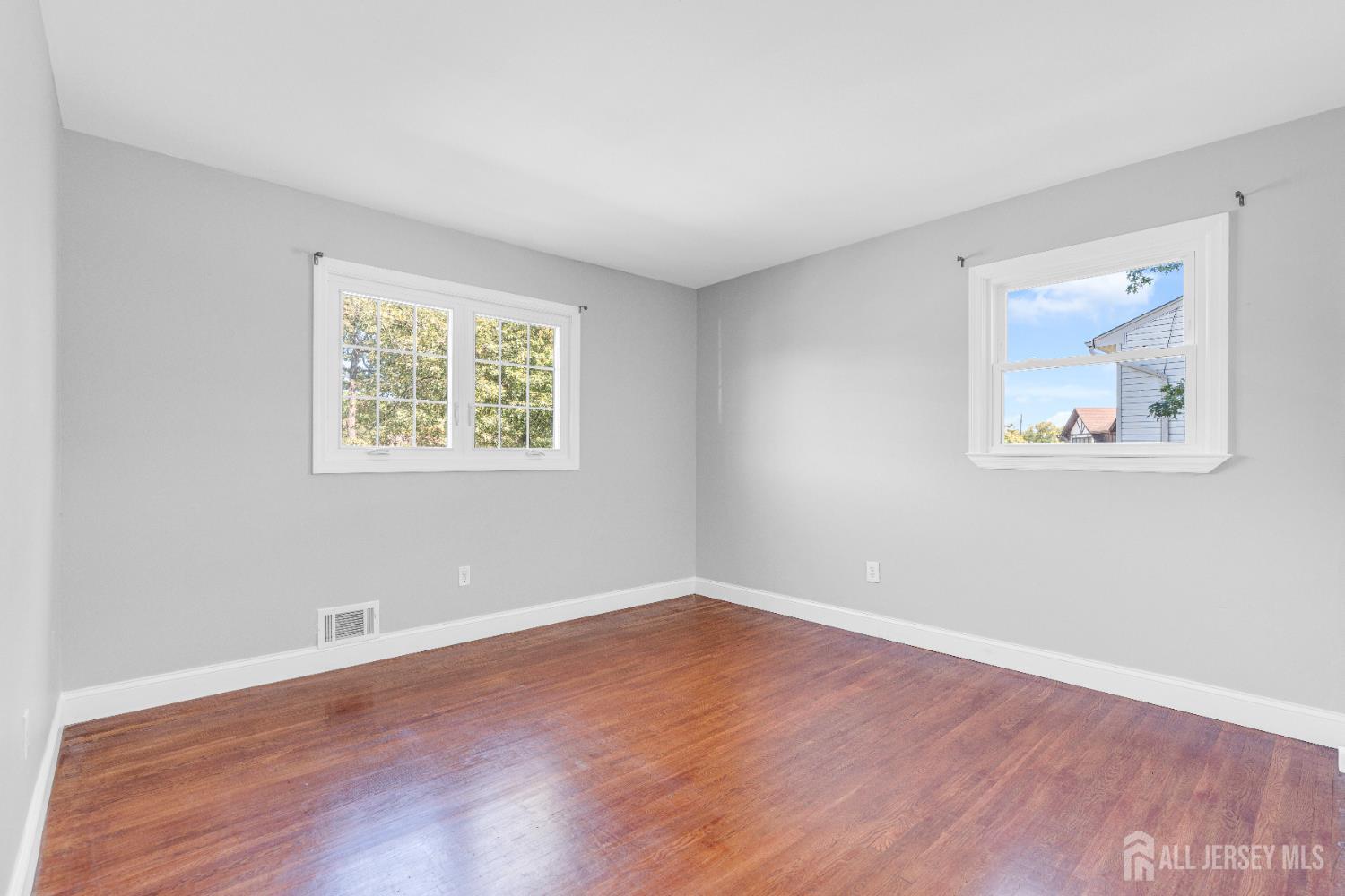 6 Marc Court Edison, NJ 08820 - Photo 23 of 42 a view of an empty room with wooden floor and a window