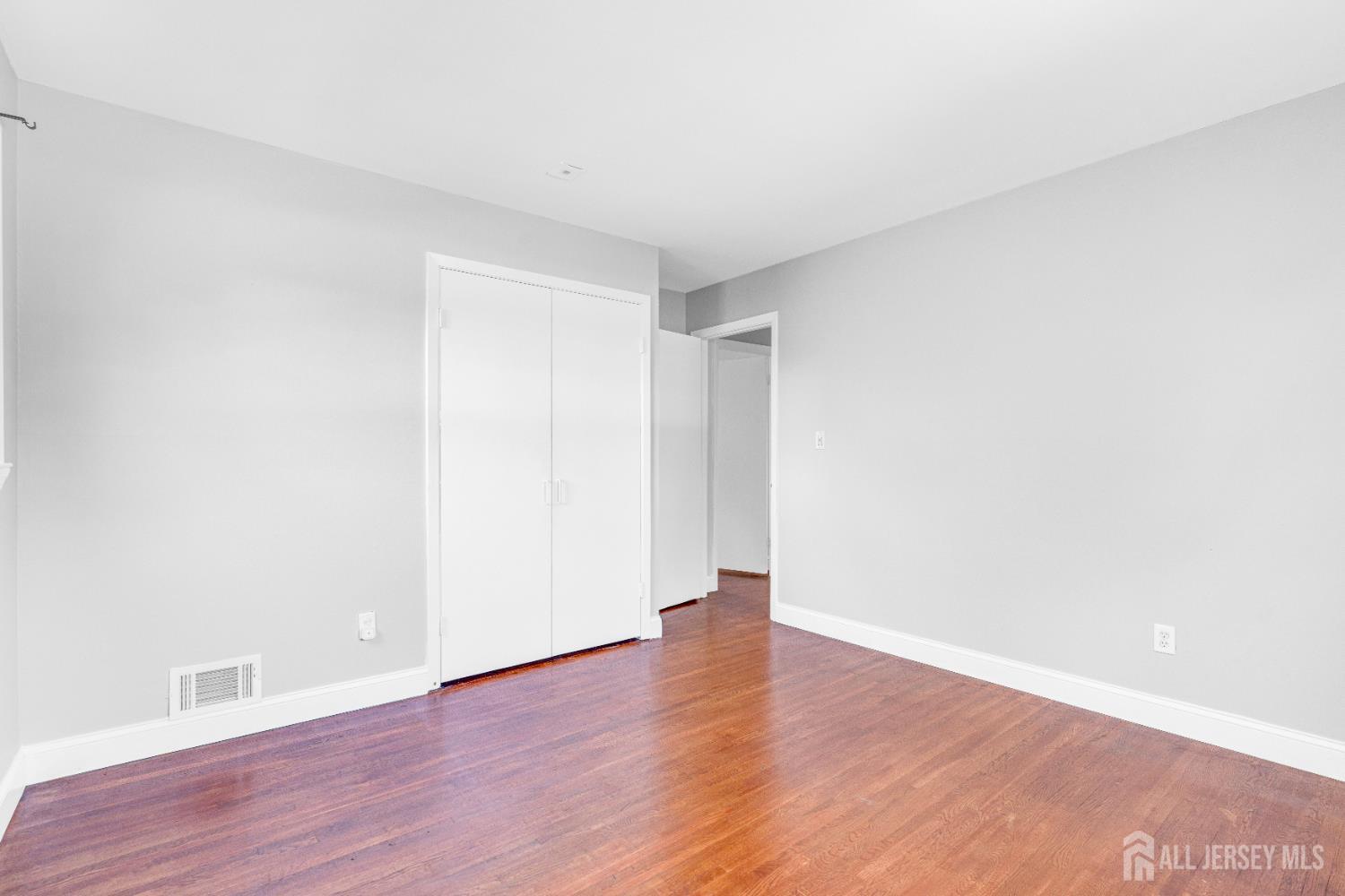 6 Marc Court Edison, NJ 08820 - Photo 24 of 42 a view of an empty room with wooden floor