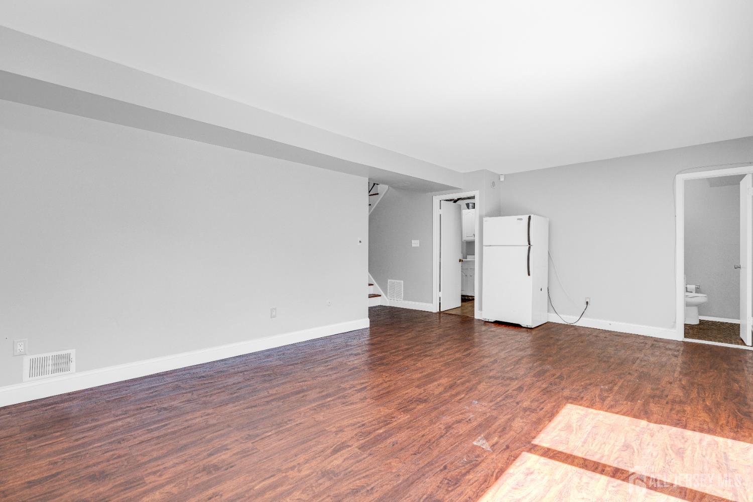 6 Marc Court Edison, NJ 08820 - Photo 27 of 42 a view of an empty room and wooden floor