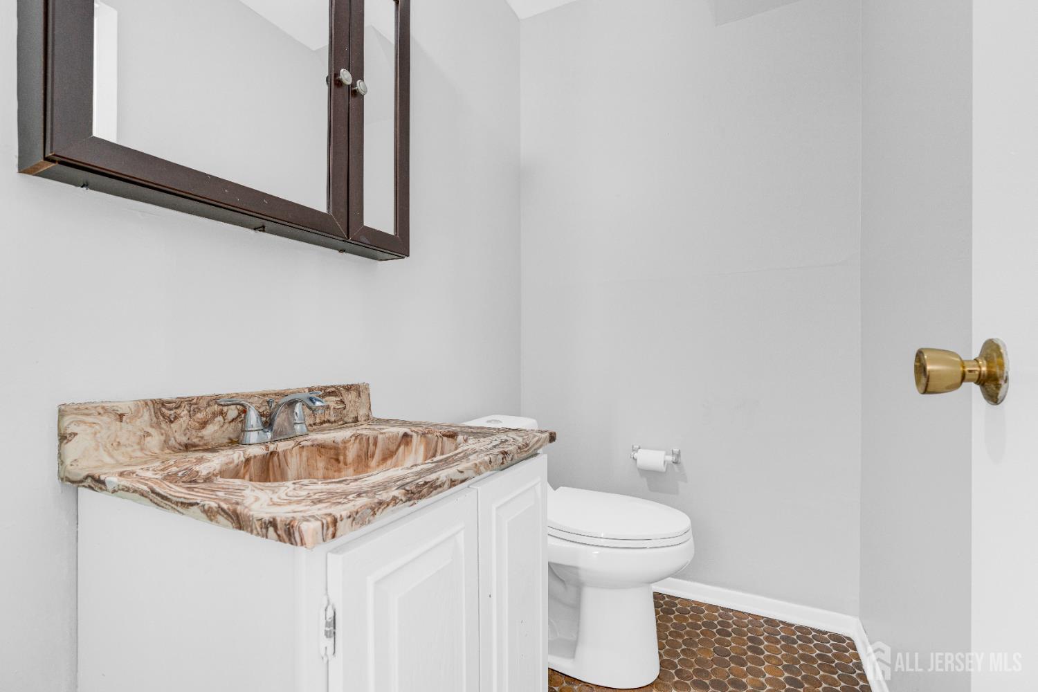 6 Marc Court Edison, NJ 08820 - Photo 28 of 42 a bathroom with a sink a toilet and a mirror