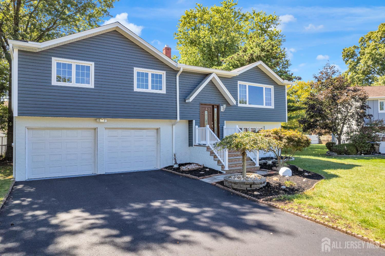 6 Marc Court Edison, NJ 08820 - Photo 3 of 42 a front view of a house with a yard