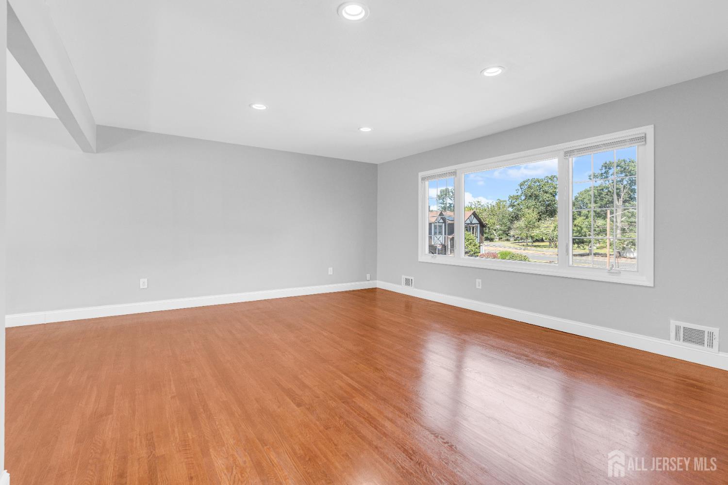 6 Marc Court Edison, NJ 08820 - Photo 6 of 42 an empty room with wooden floor and windows