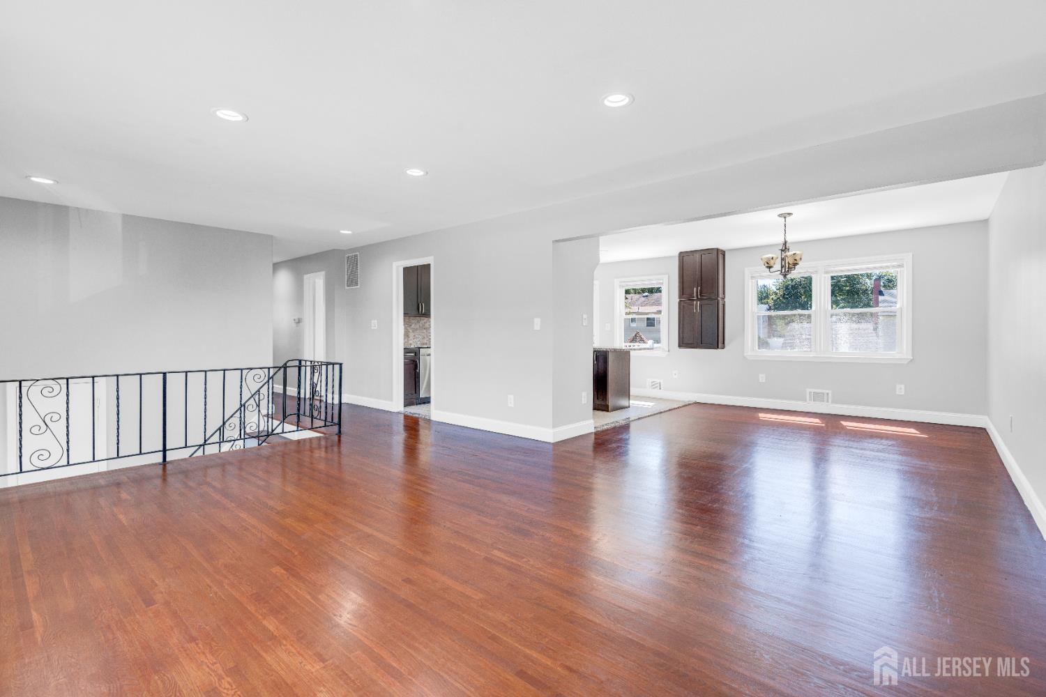 6 Marc Court Edison, NJ 08820 - Photo 8 of 42 a view of an empty room with wooden floor and a window
