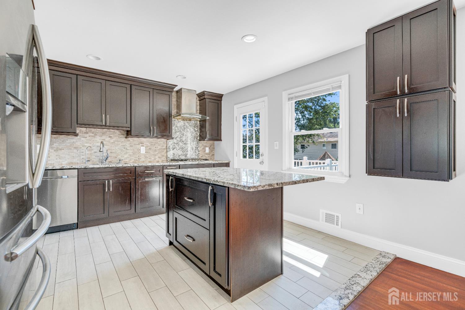 6 Marc Court Edison, NJ 08820 - Photo 9 of 42 a kitchen with stainless steel appliances granite countertop a stove a sink and a refrigerator