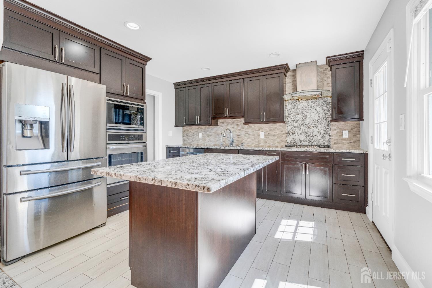 6 Marc Court Edison, NJ 08820 - Photo 10 of 42 a kitchen with granite countertop stainless steel appliances and wooden cabinets