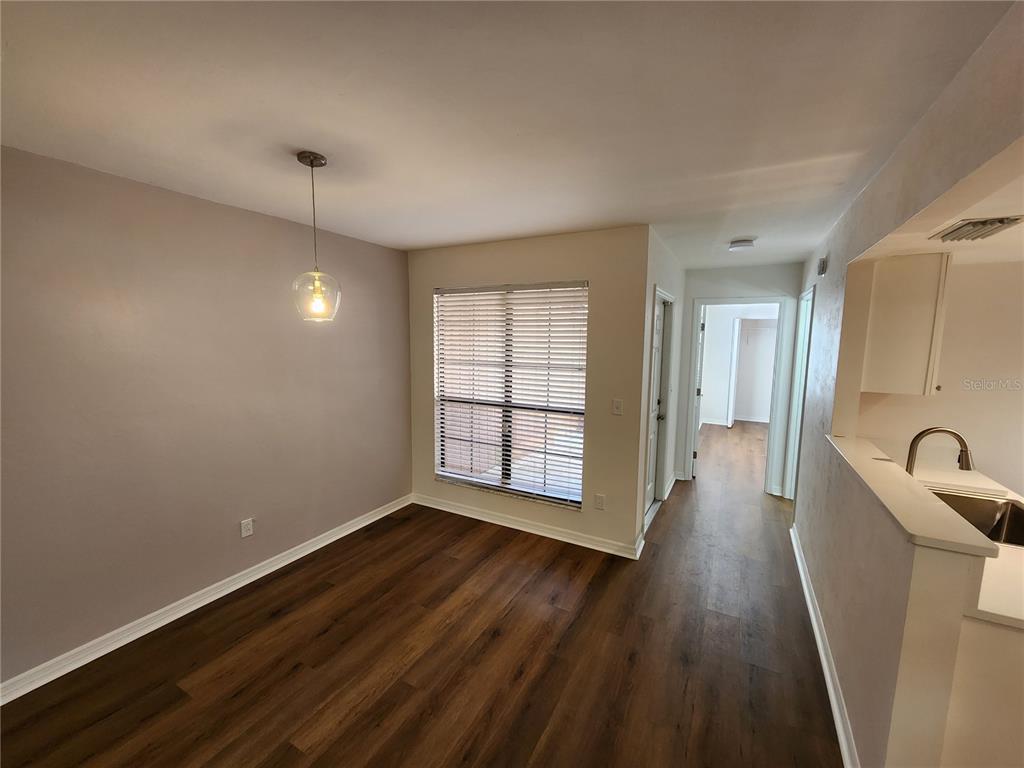5823 Southwest 9th Place, Unit H55 Gainesville, FL 32607 - Photo 23 of 50 a view of a room with wooden floor and window