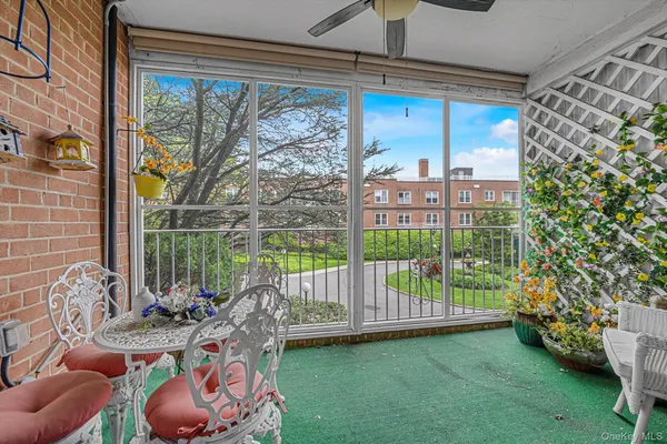 a view of a porch with furniture and garden