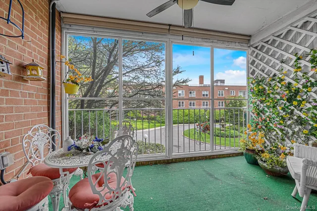 a view of a porch with furniture and garden