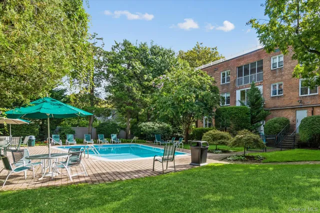 a view of a chair and table in the garden