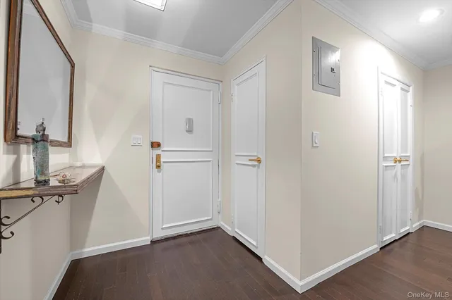 an empty room with wooden floor and mirror