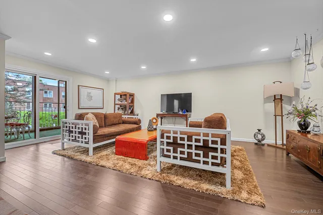 a living room with furniture rug and wooden floor