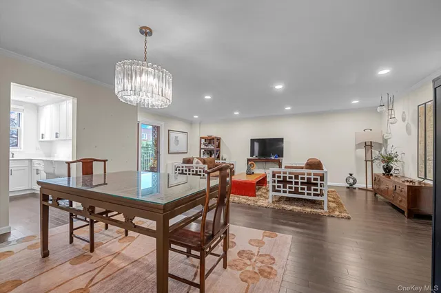 a view of a dining room with furniture wooden floor and chandelier