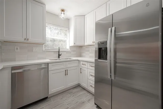 a kitchen with a refrigerator and a sink