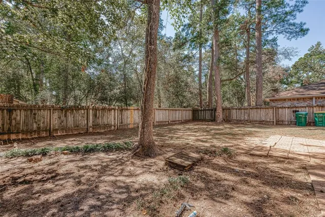a view of a yard with trees in the background