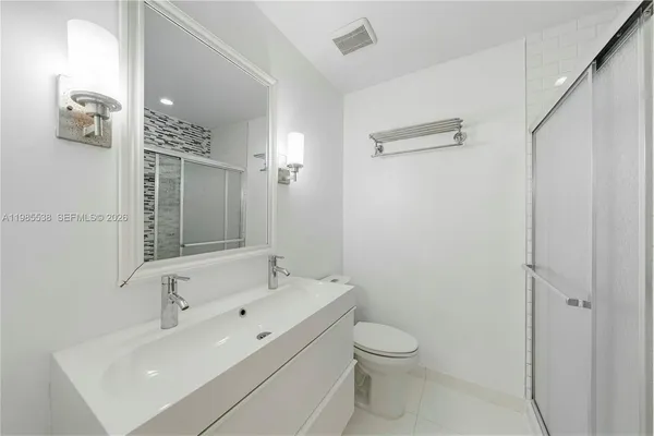 a bathroom with a toilet sink shower and mirror