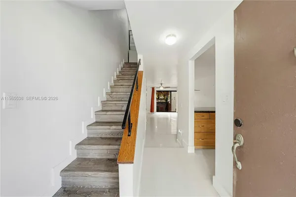a view of entryway and hall with wooden floor