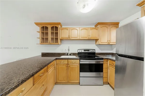 a kitchen with stainless steel appliances granite countertop a stove and a refrigerator