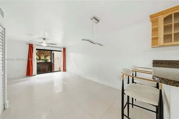 a furnished livingroom with windows and furniture