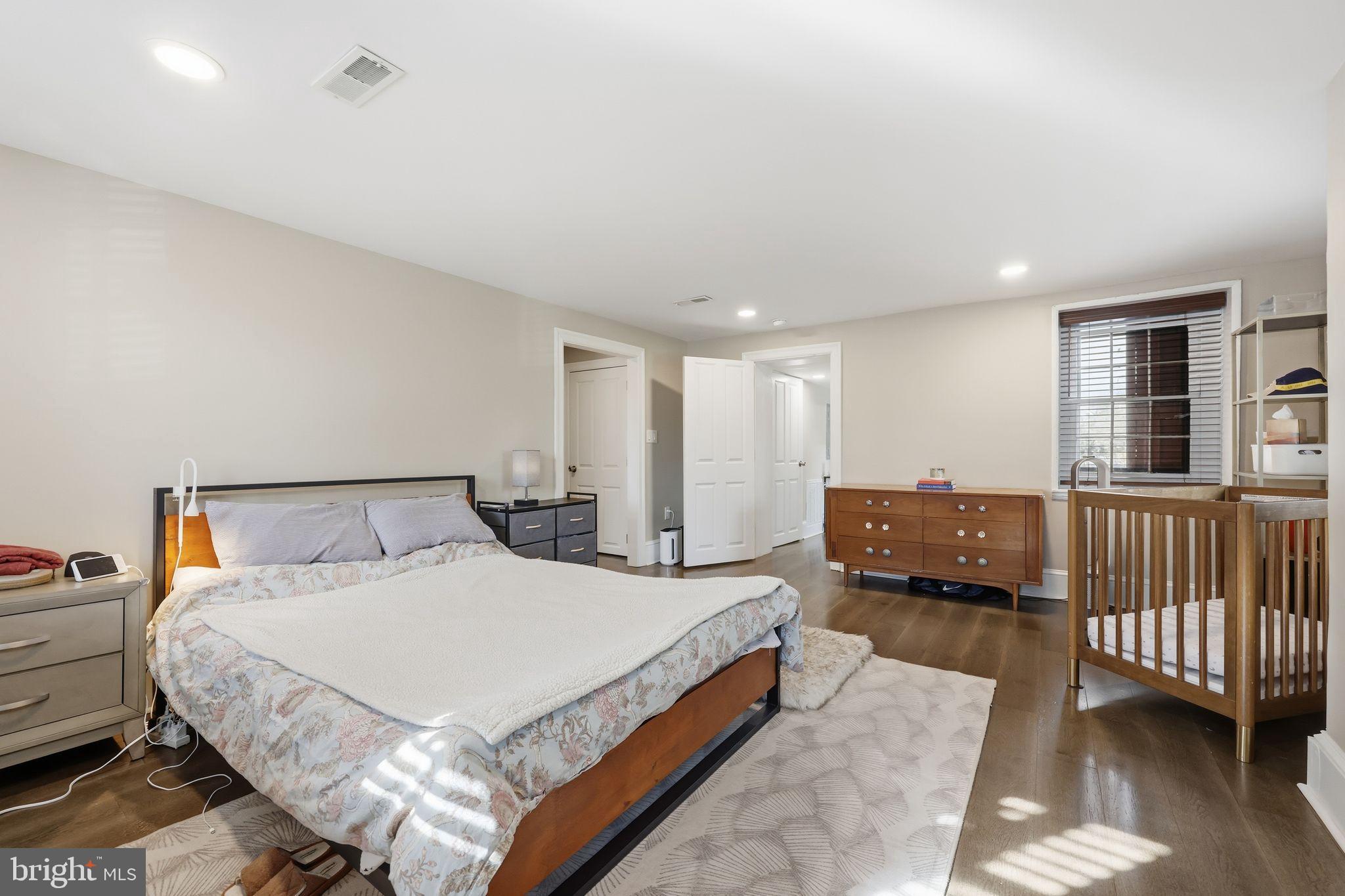 126 North Providence Road Media, PA 19063 - Photo 13 of 28 a spacious bedroom with a bed a couch and a window