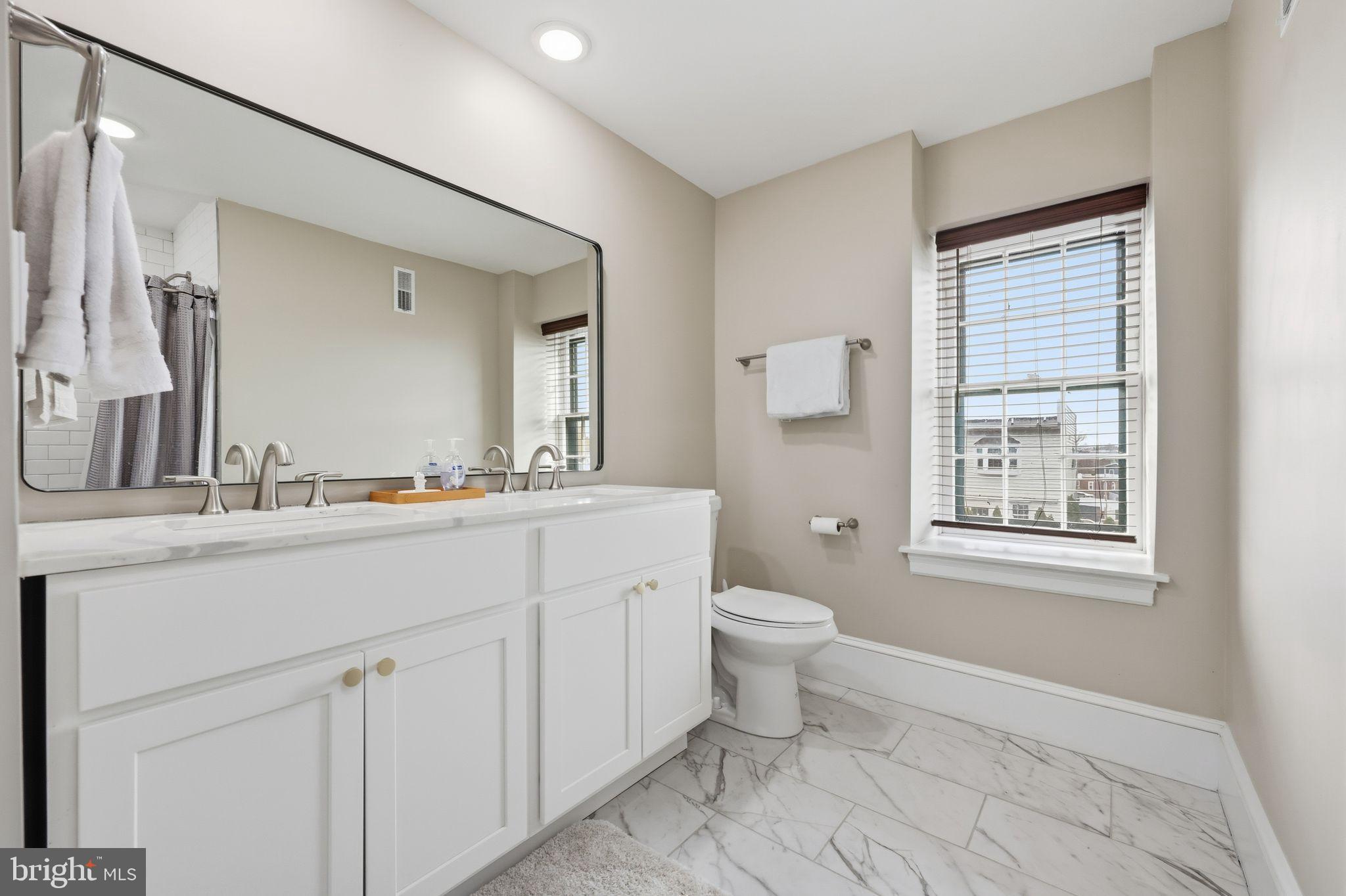 126 North Providence Road Media, PA 19063 - Photo 22 of 28 a bathroom with a sink toilet a mirror and vanity