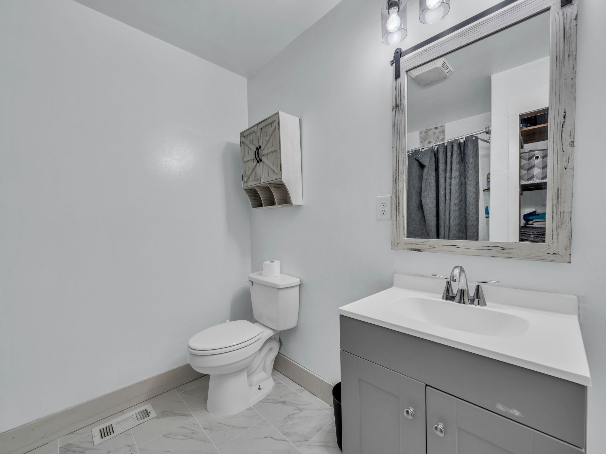 4055 Erin Road McEwen, TN 37101 - Photo 13 of 25 a bathroom with a toilet a sink and mirror