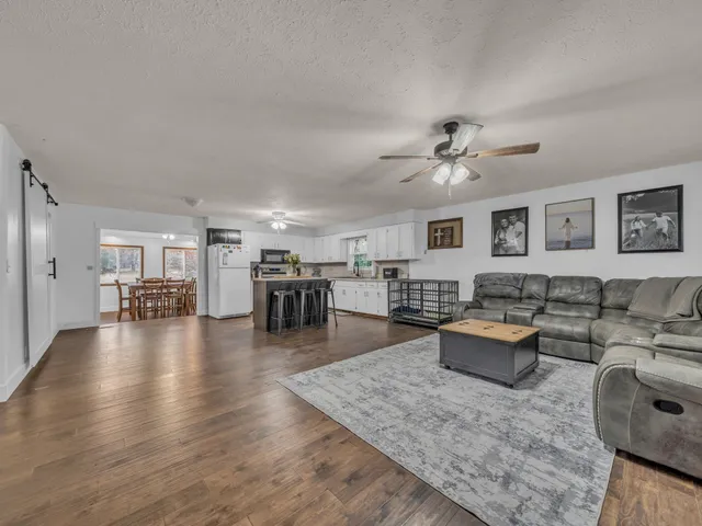 a living room with furniture and wooden floor