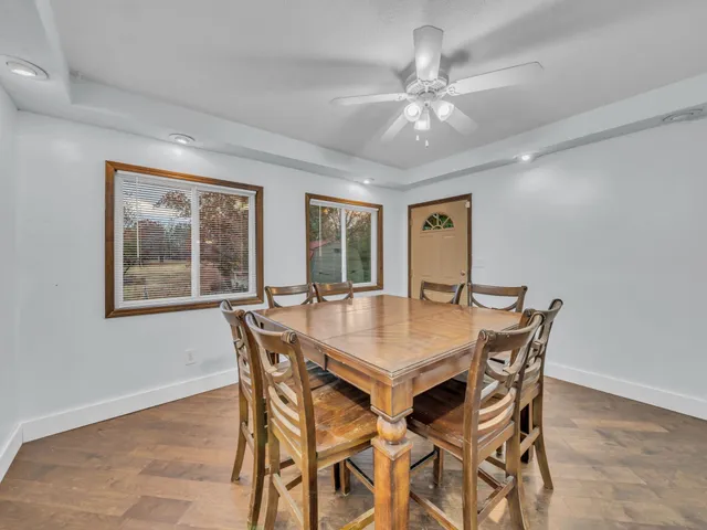 a view of a dining room with furniture and a chandelier