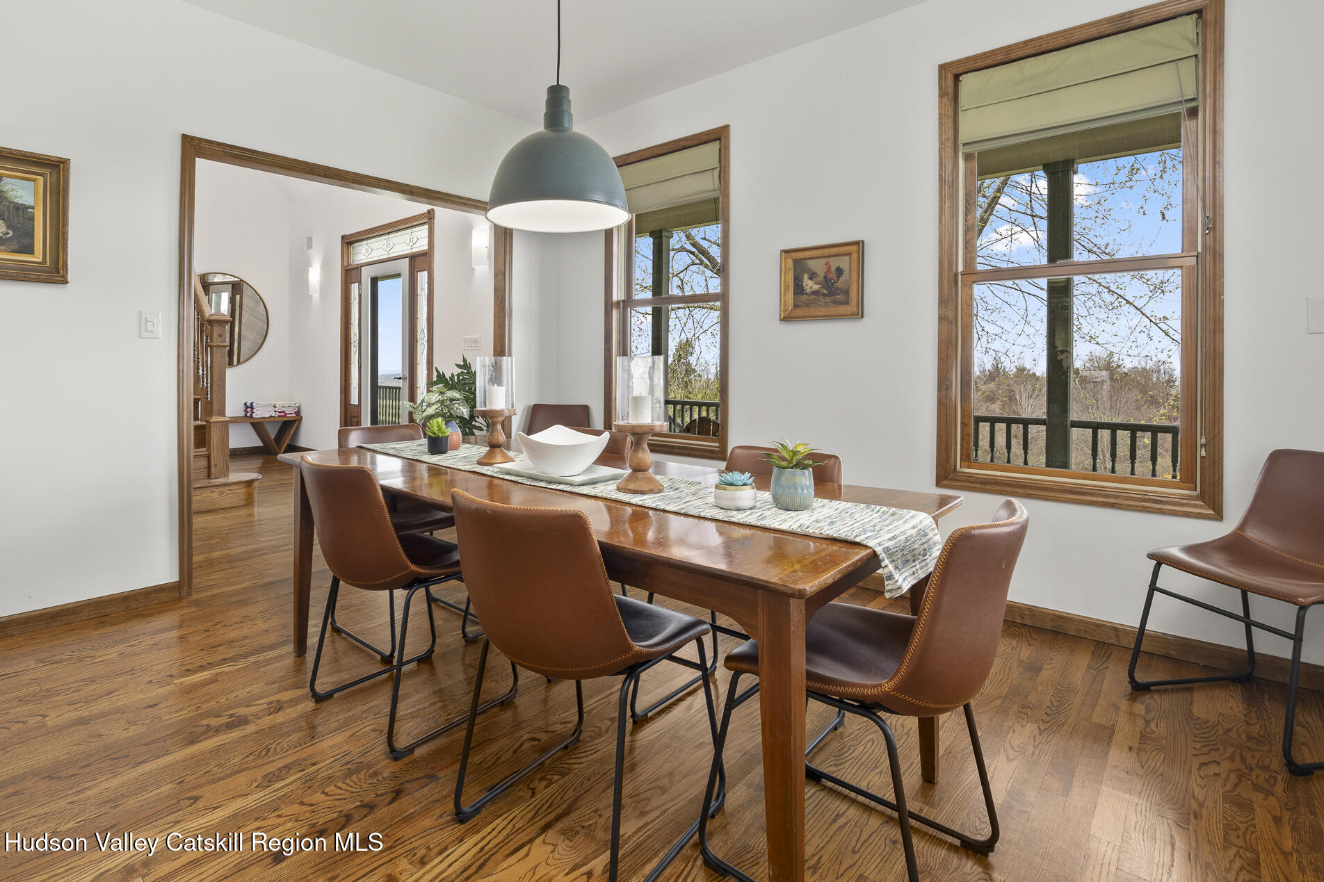 350 Taghkanic Road Elizaville, NY 12523 - Photo 15 of 36 a dining room with wooden floor a chandelier a wooden table and chairs