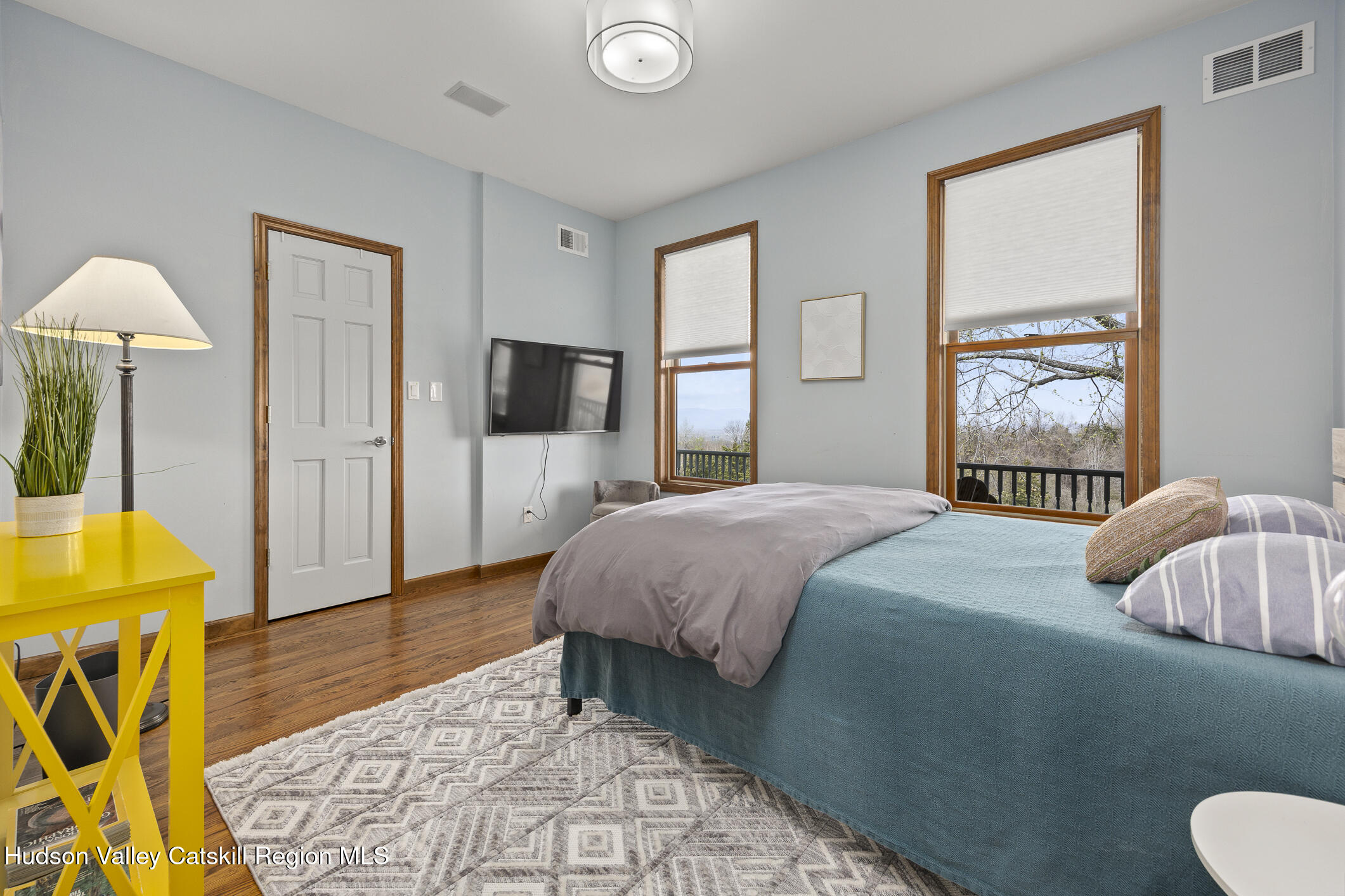 350 Taghkanic Road Elizaville, NY 12523 - Photo 20 of 36 a bedroom with a bed and wooden floor