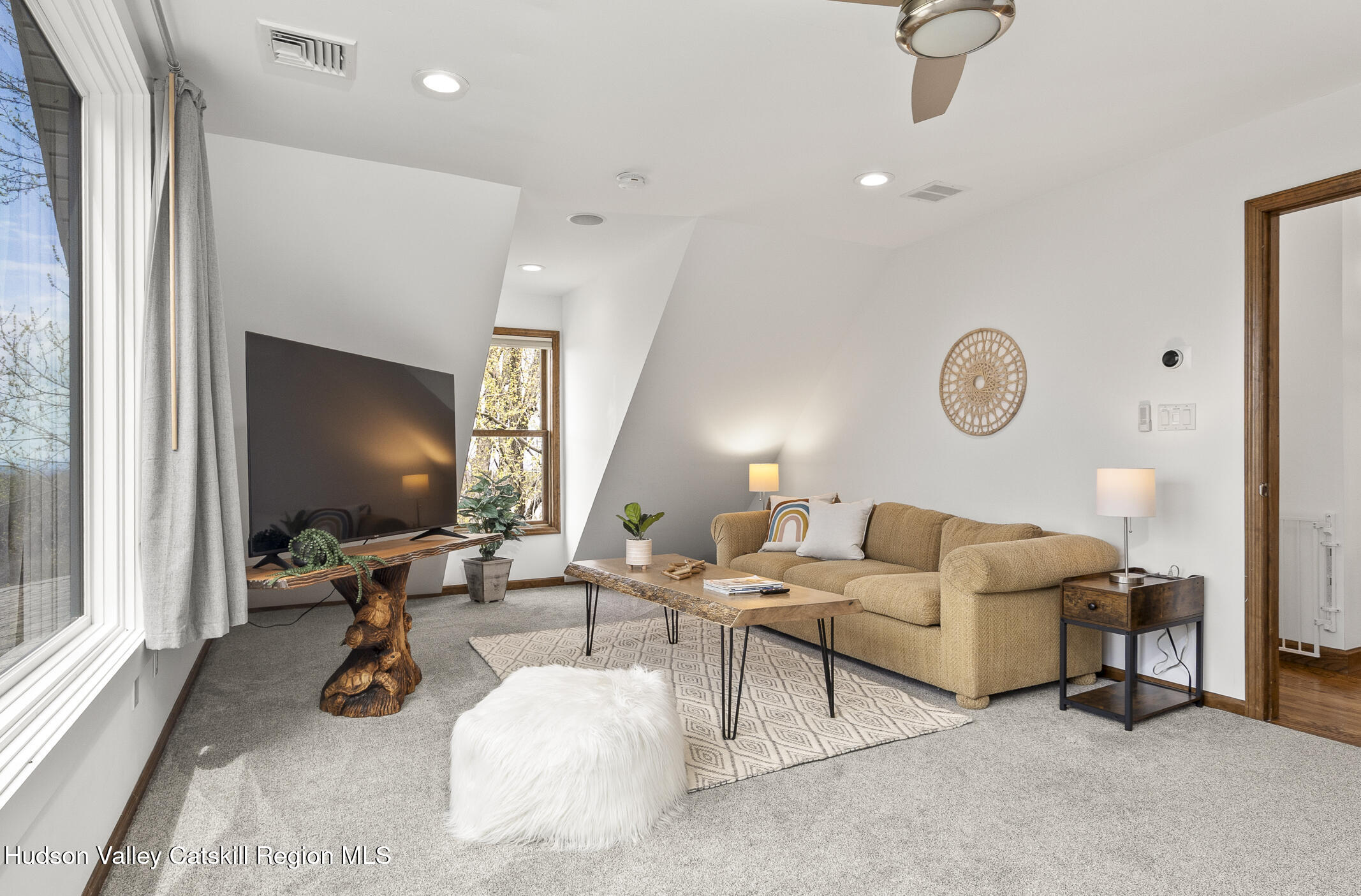 350 Taghkanic Road Elizaville, NY 12523 - Photo 24 of 36 a living room with furniture gym equipment and a large window